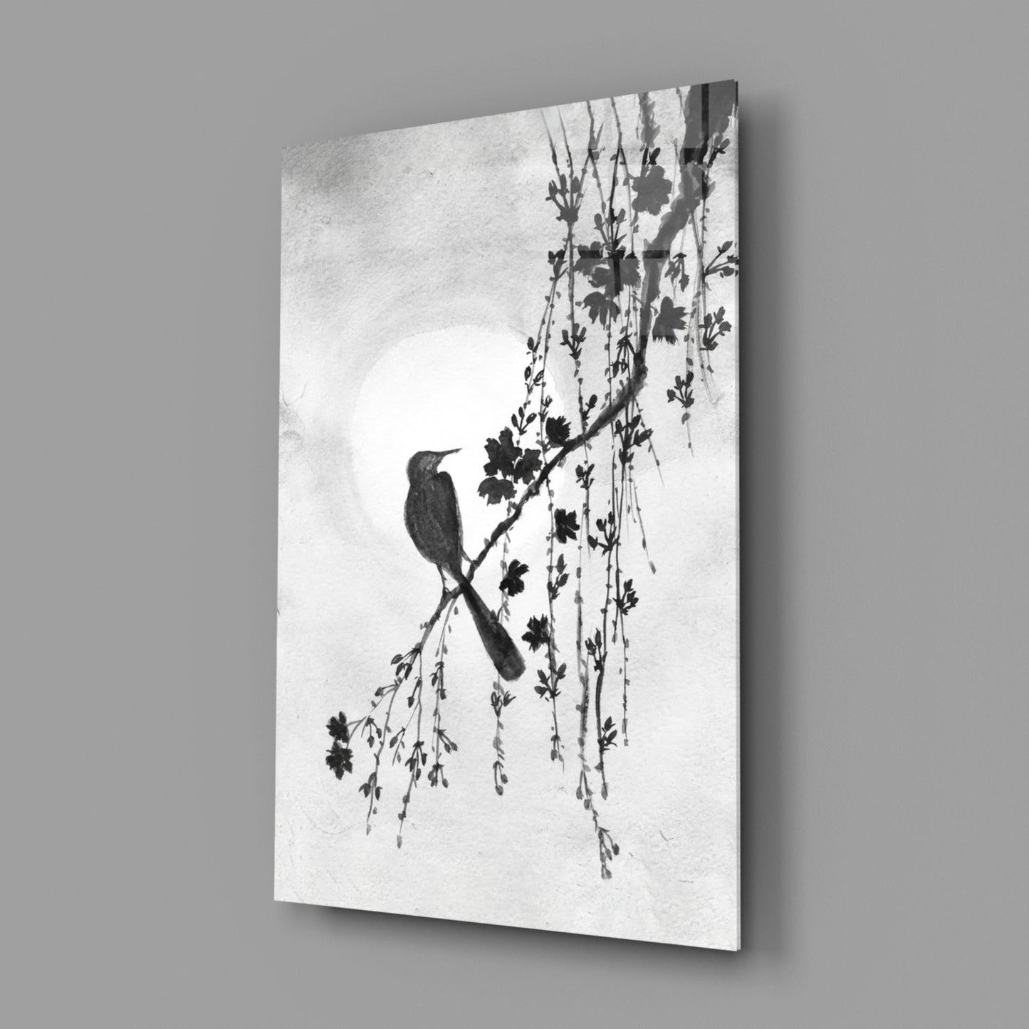 Glass print with a black and white bird and branch design on a gray background