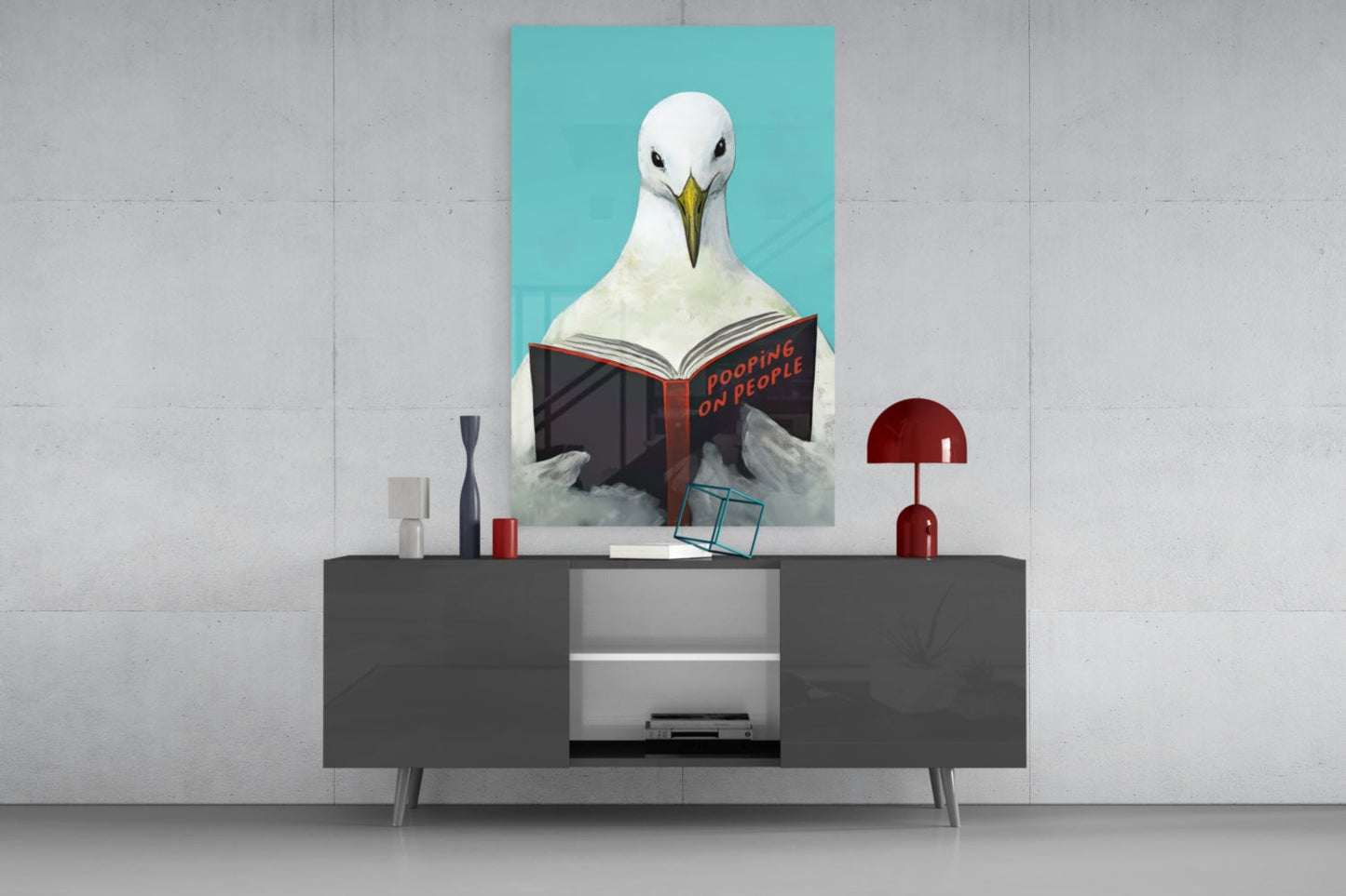 Œuvre murale en verre représentant une mouette lisant un livre sur fond Turquoise