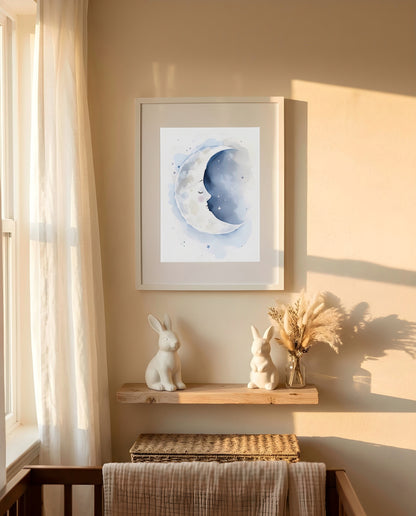 Nursery Sleeping Moon Soft Watercolor Minimal Printable Wall Art — framed in white on a neutral nursery wall