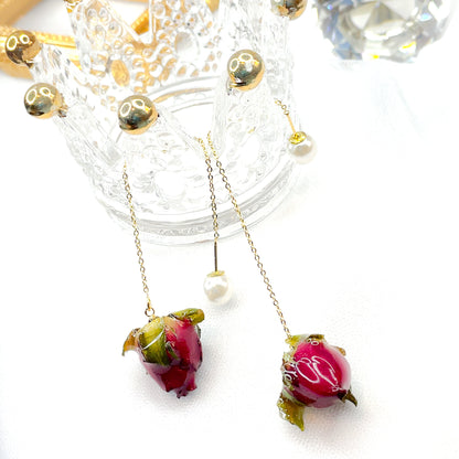 Orecchini a filo con boccioli di rosa conservati